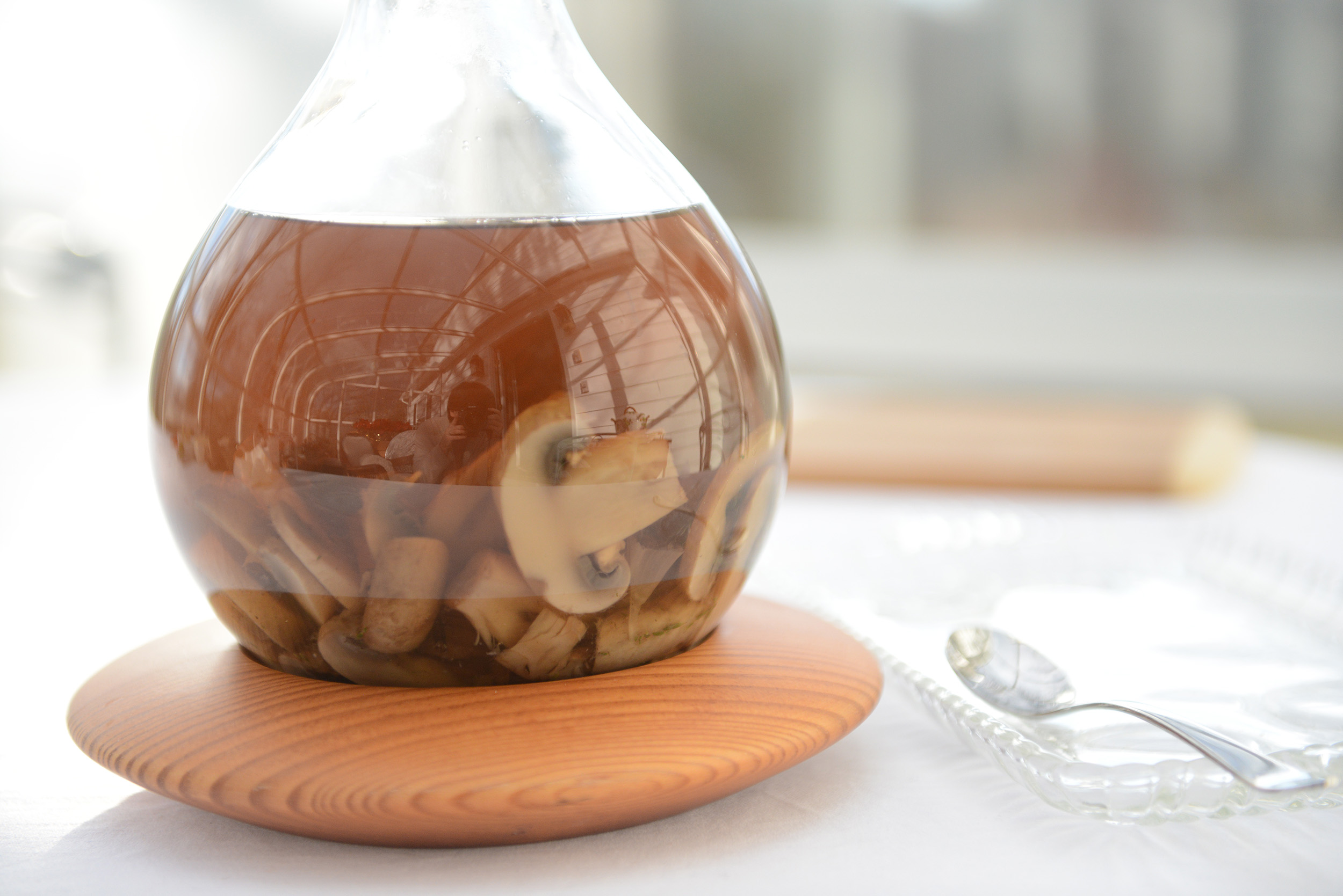 Container of mushroom broth in the sun