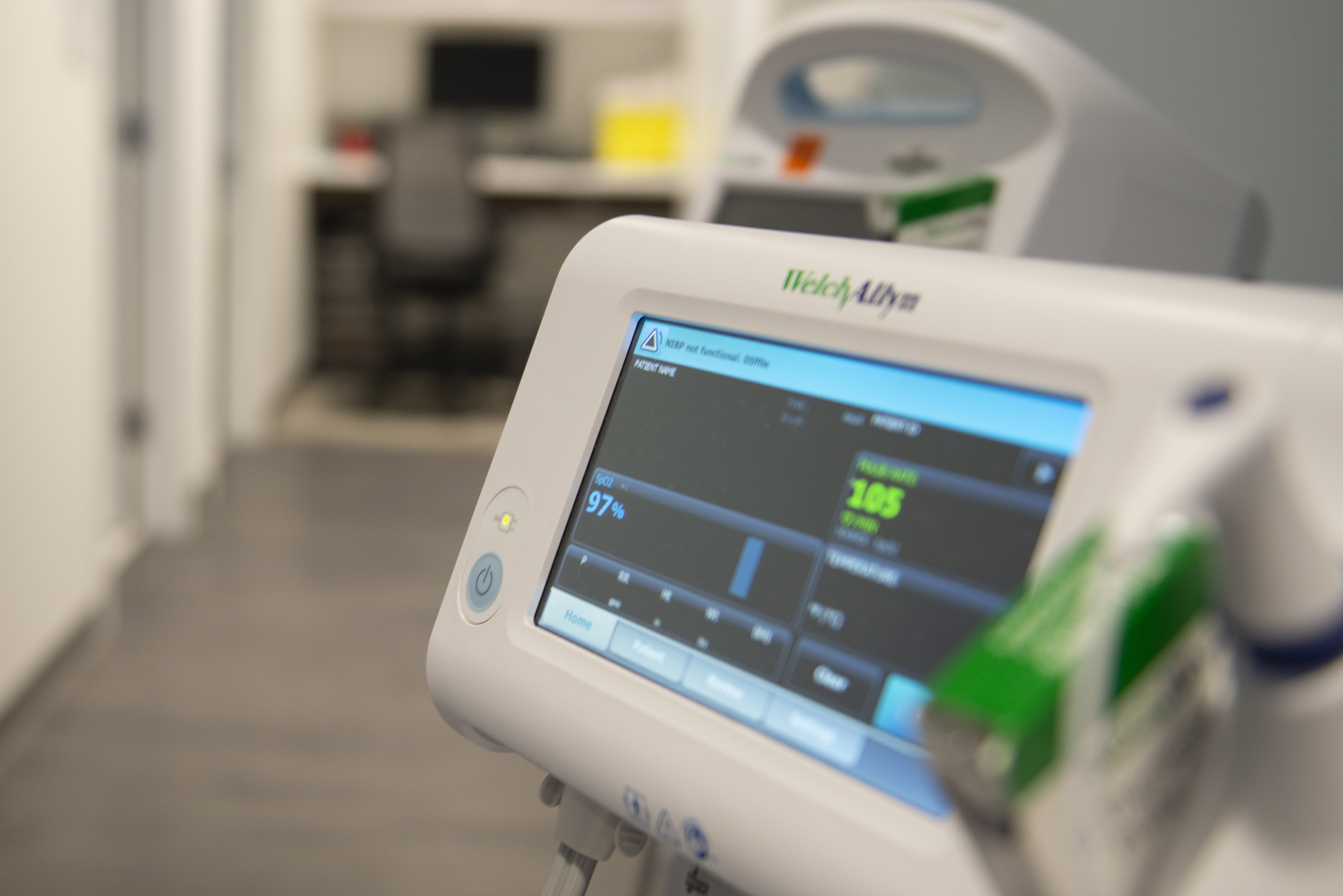 Physician examining table and blood pressure machine